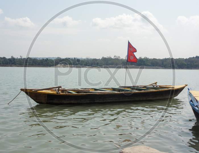 A Boat On River With Flag Of Nepal