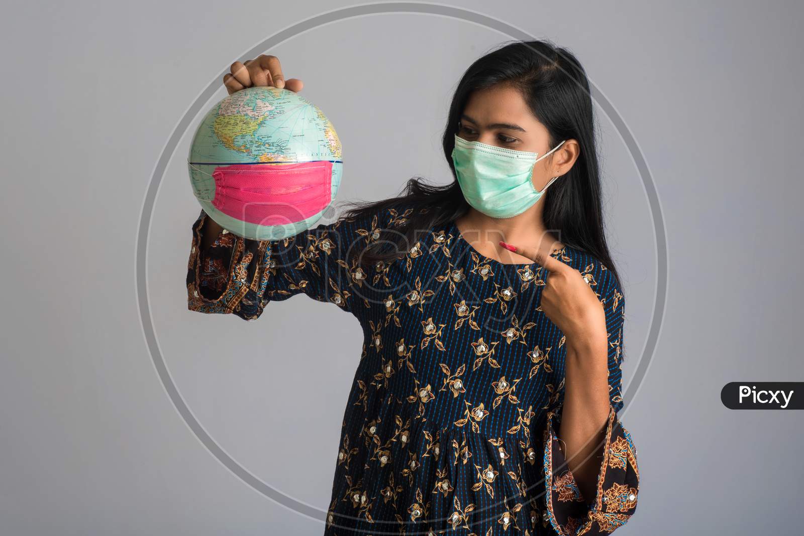 Young Girl Holding World Globe With A Medicine Face Mask. World Epidemic Of Coronavirus Concept.