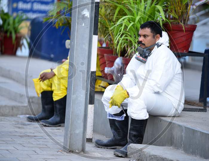 Disaster Response Force(DRF) team with full body suitstaking rest after spraying Disinfectant Solution across the Hyderabad City to reduce the spread of the COVID-19 Virus or Coronavirus