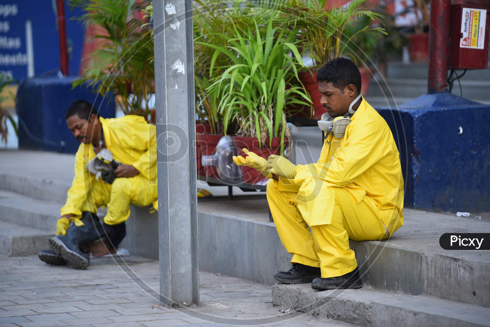 Disaster Response Force(DRF) team with full body suits taking rest after spraying Disinfectant Solution across the Hyderabad City to reduce the spread of the COVID-19 Virus or Coronavirus