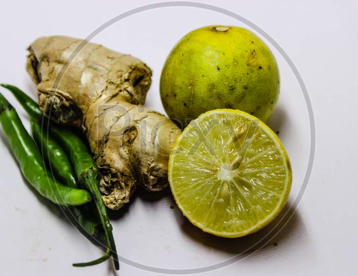 Ginger, Green Chilli And Lemon  Over An Isolated White Background