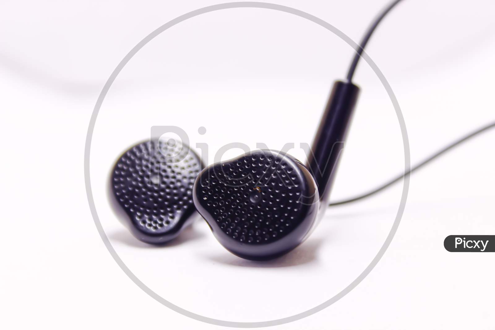 Black Earphones Buds Over An Isolated White Background