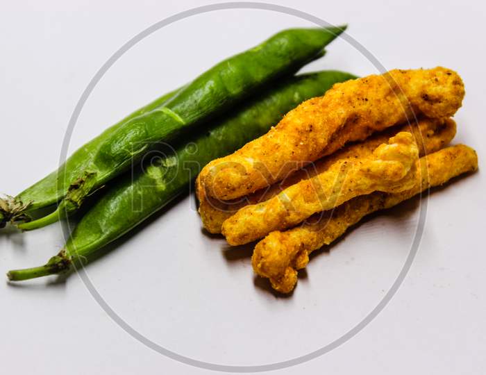 Turmeric Roots And Green Peas Over An Isolated White Background