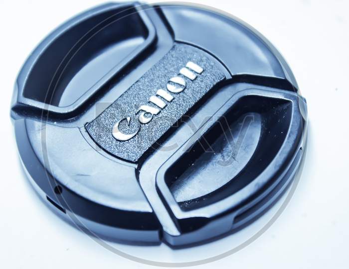 Canon Lens Cap Over an Isolated White Background
