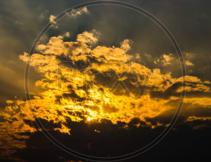 Sunset Sky With Golden Tint And Clouds Forming a Background
