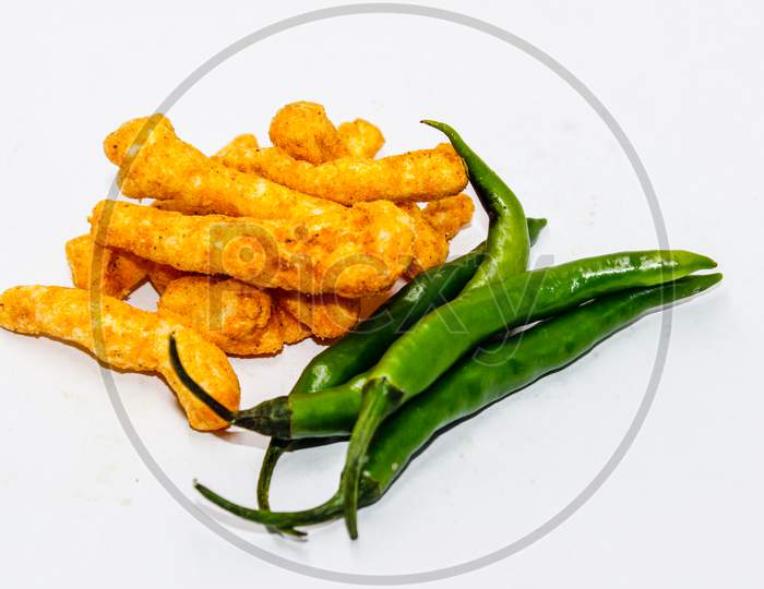 Yellow turmeric Roots And green Chilles Over An Isolated White Background