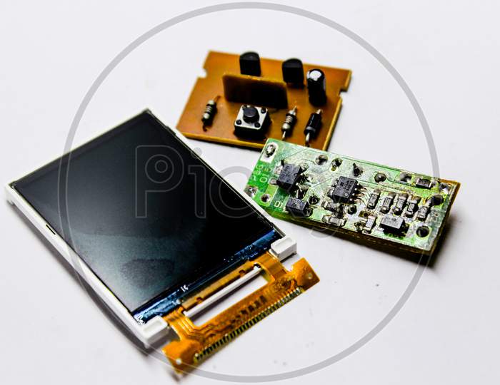 Electronic Device Interior Parts Mother Board And Display Panel Over an Isolated White Background