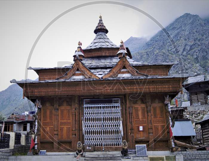 A close up view of beautiful temple in Himachal Pradesh constructed by wooden.