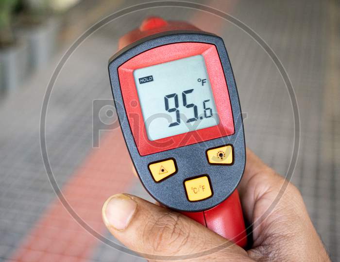 Infrared thermometer is being used to check people with high temperature amid corona virus covid-19 outbreak in india