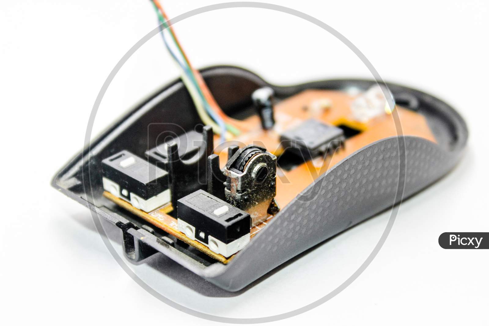 Optical Mouse Wide Open With Interior Circuit And Mother Board Over an Isolated White Background