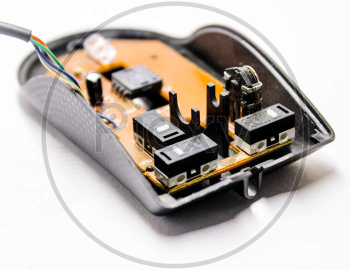 An Optical Mouse Wide opened With Interior Motherboard Over an Isolated White Background