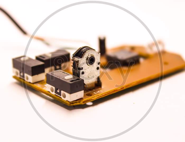 Mother Board of an Optical Mouse  Device With Amplifier And Micro Condensers Over An Isolated White Background
