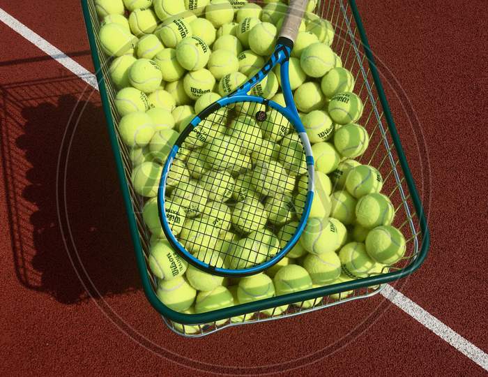 Tennis balls in a cart