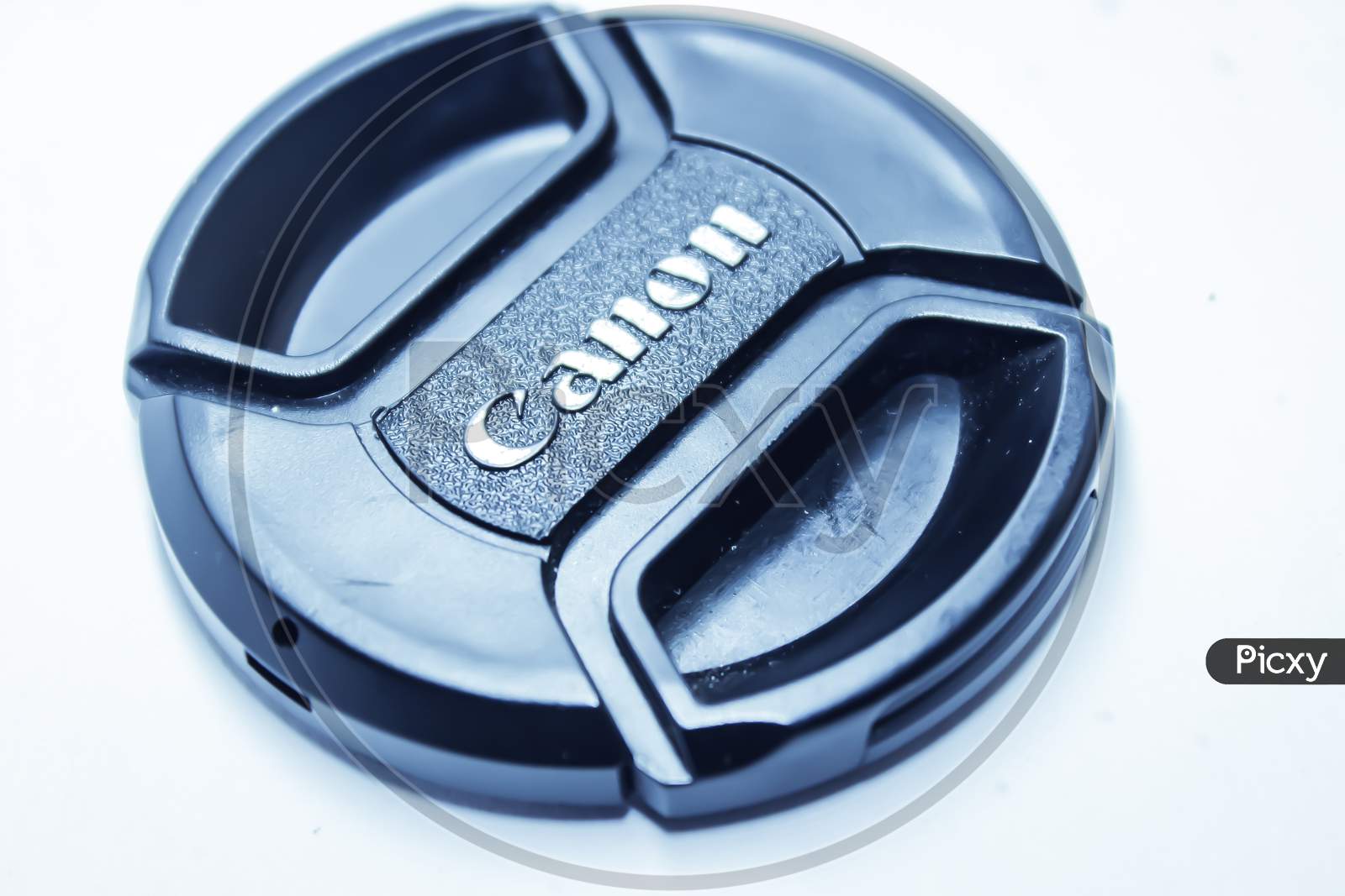 Canon Lens Cap Over an Isolated White Background