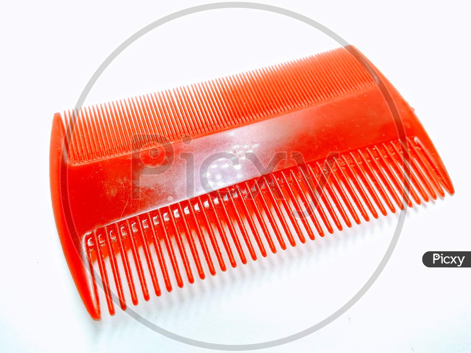 Plastic Comb Over an Isolated White Background