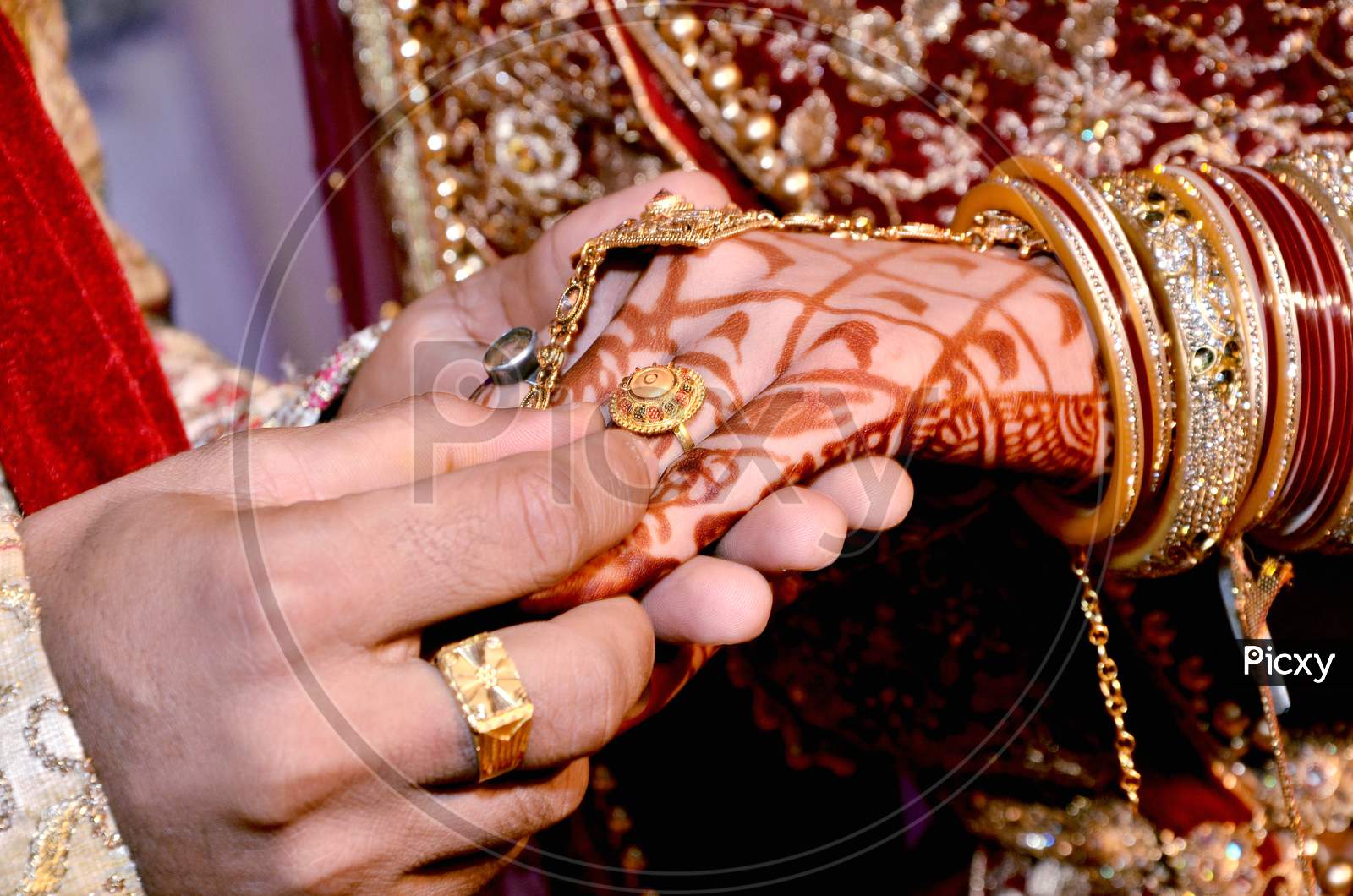 Close Up On Hand Of A Man Put On An Engagement Ring On The Finger Of The Bride