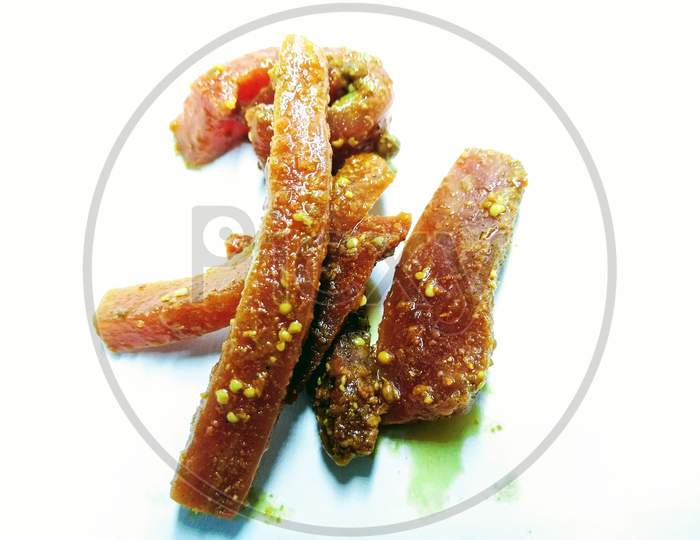 dried Mango Pickle Pieces Over an Isolated White  Background
