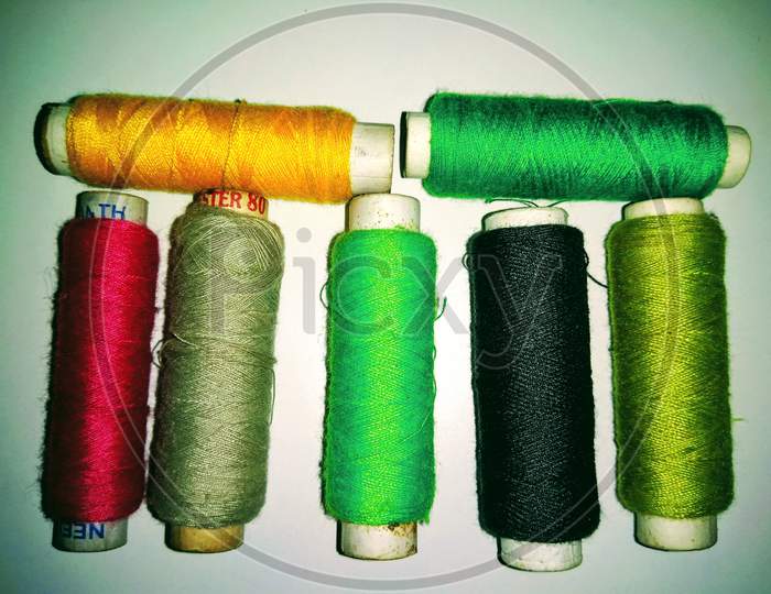 Colourful Thread Rolls On White Background