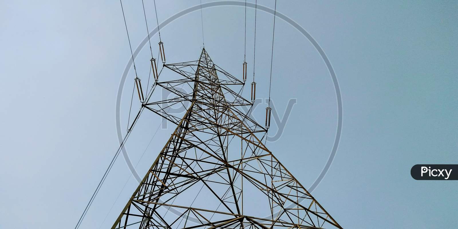 A View of Electric High tension Pole Over Sky