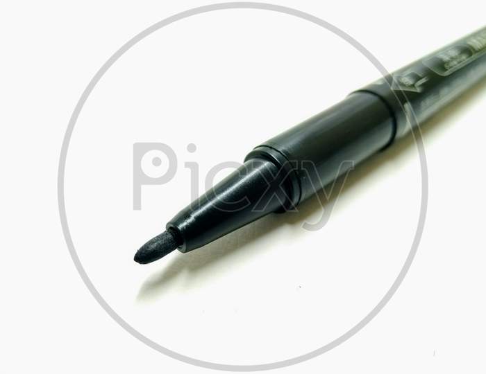 Black Sketch Pen Over an Isolated White  Background