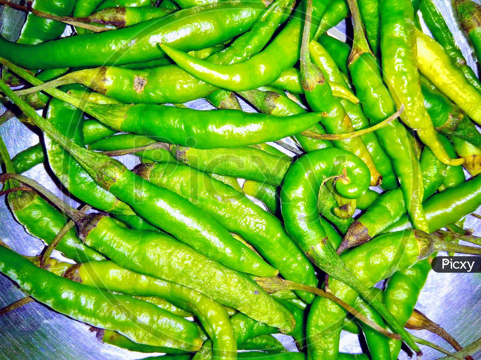Green Chillies Closeup Forming a Background