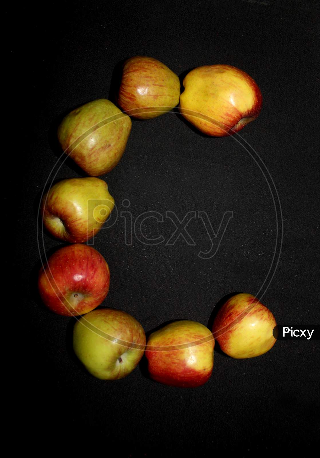 Alphabetical Letter C With Apples Over An isolated Black Background