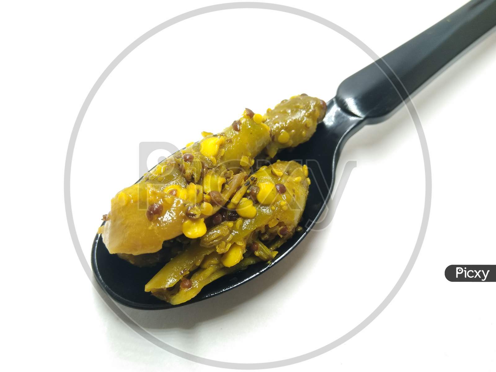 Dried Mango Pickle Over an Isolated White Background