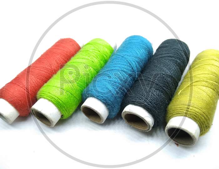 Colourful Thread Rolls On White  Background