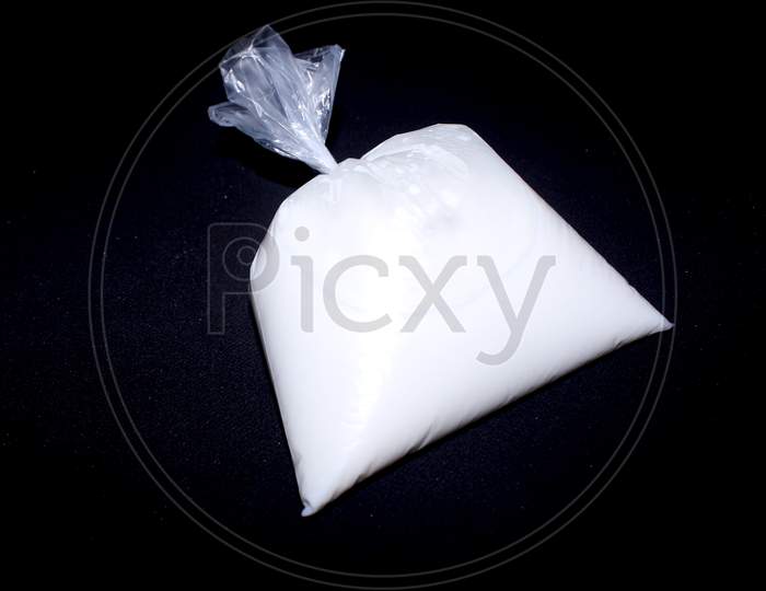 Milk Packet Over An Isolated Black Background