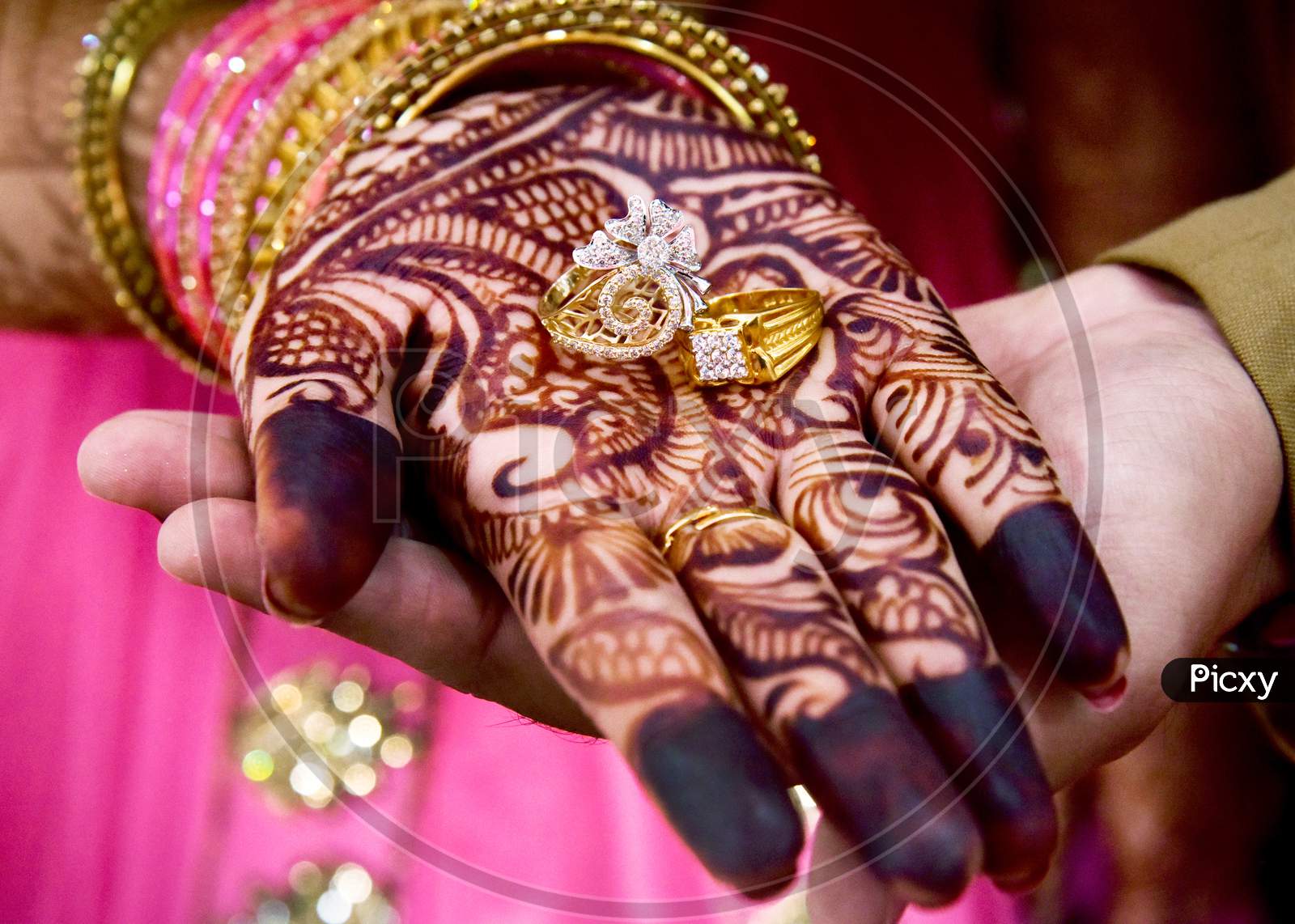 Gold Wedding Rings Are On The Bride'S Hand