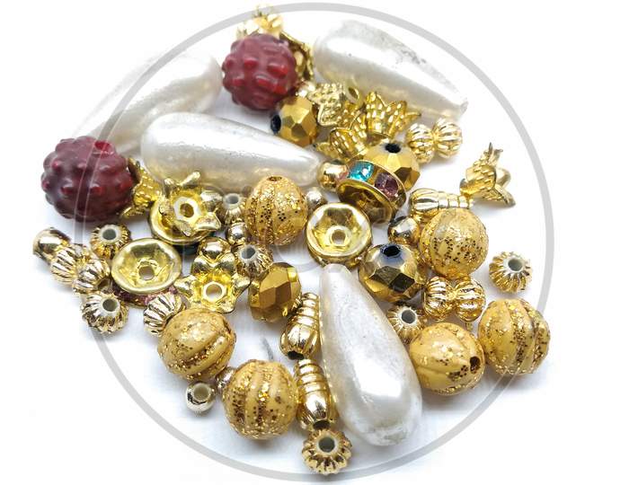 Gold Jewelery beads on isolated White