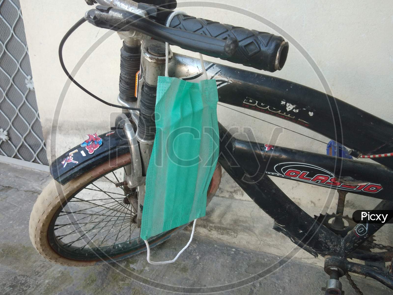 A mask hanging on a child bicycle