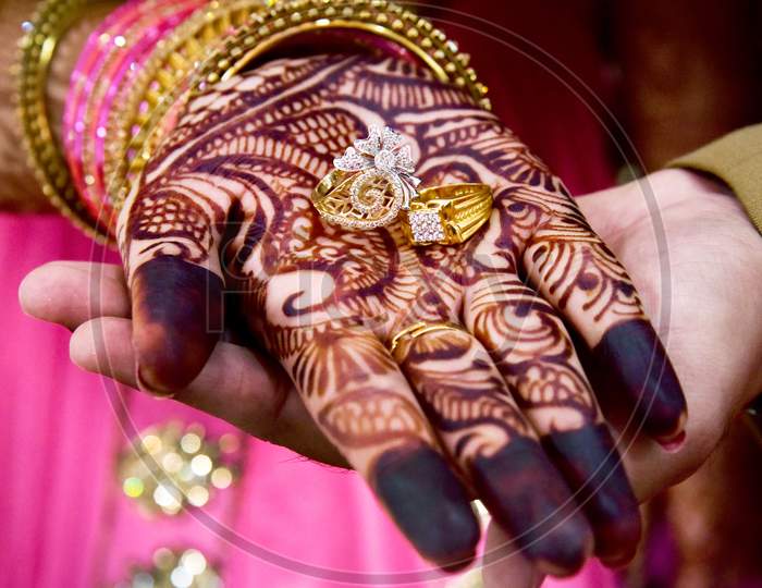 Gold Wedding Rings Are On The Bride'S Hand