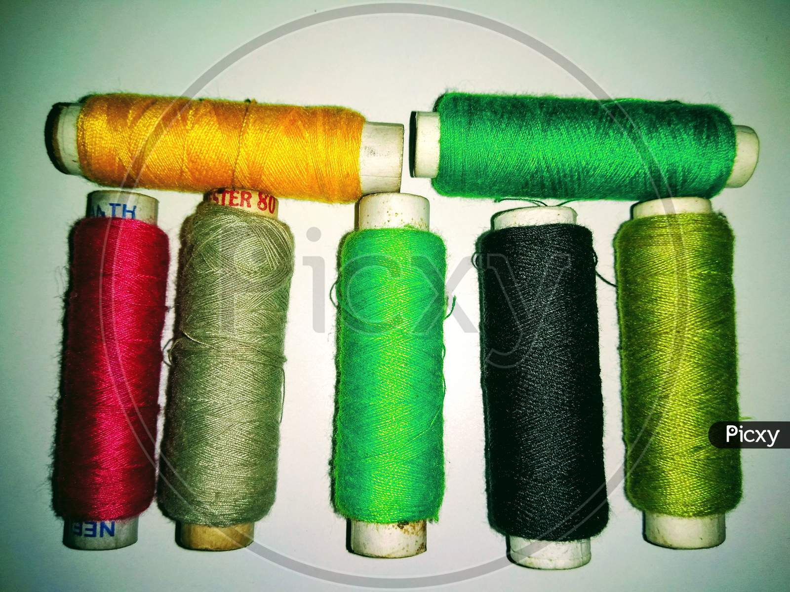 Colourful Thread Rolls On White Background