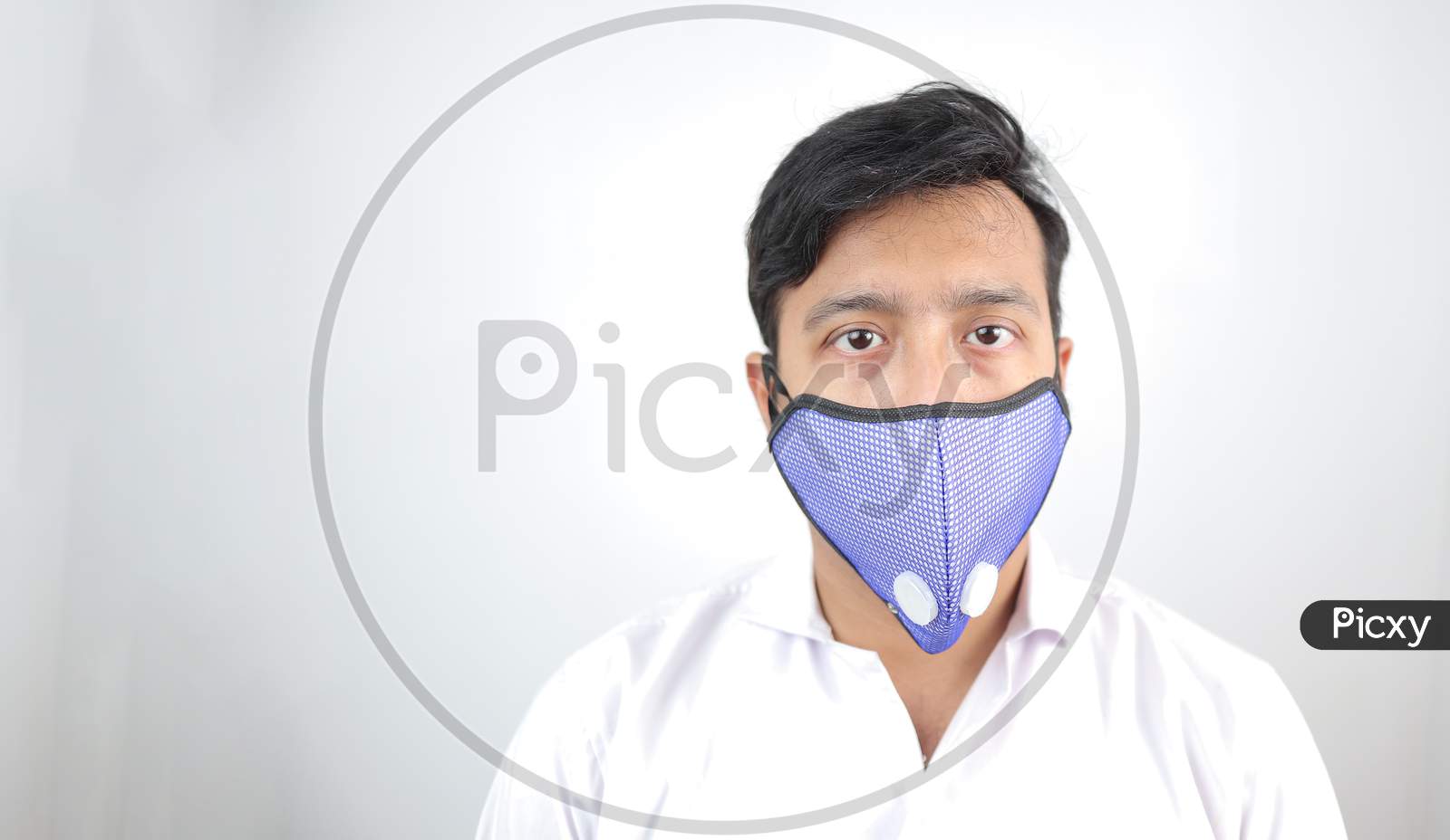 a male medical professional in white coat and mask in white background. stressed out doctor. concept image for viral infection precaution.