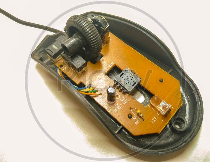 Optical Mouse Wide Opened With Internal Parts Over an Isolated white Background