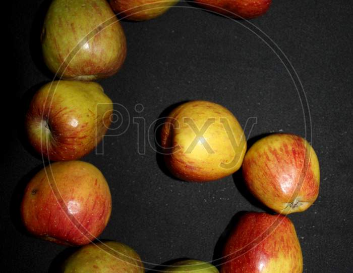 Alphabetical Letter G With Apples Over An isolated Black Background