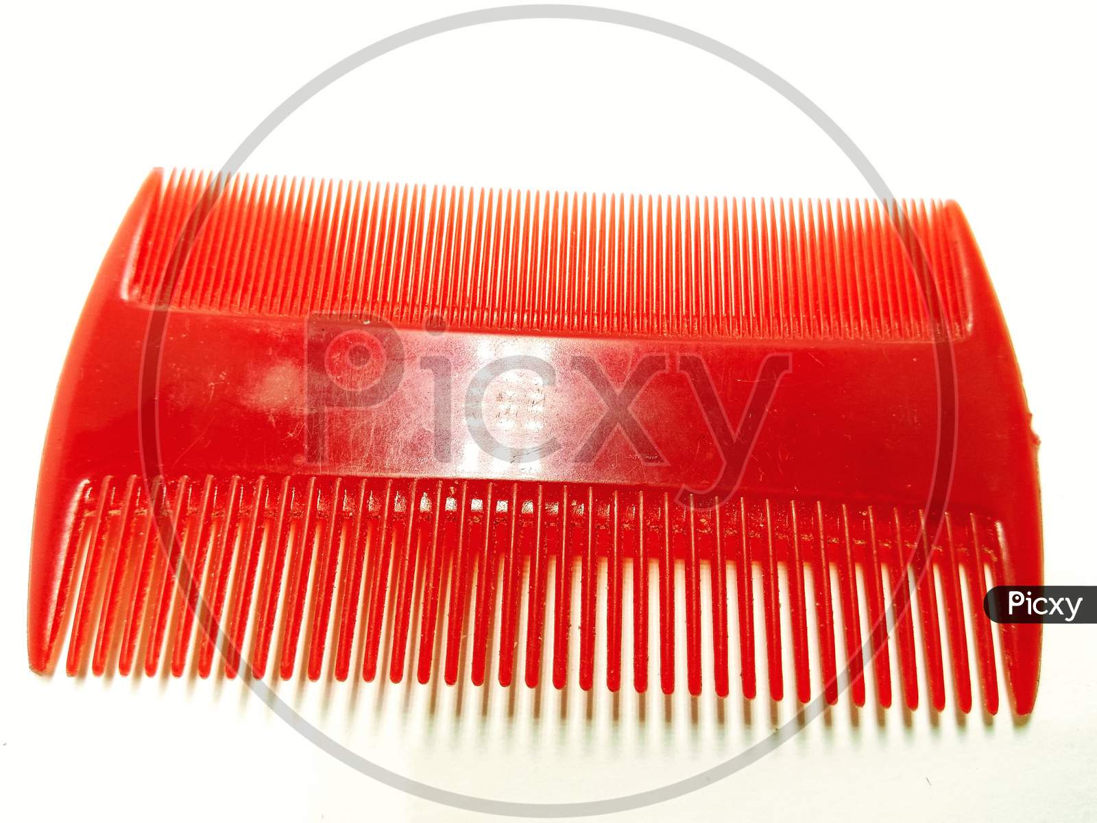 Plastic Comb Over an Isolated White Background