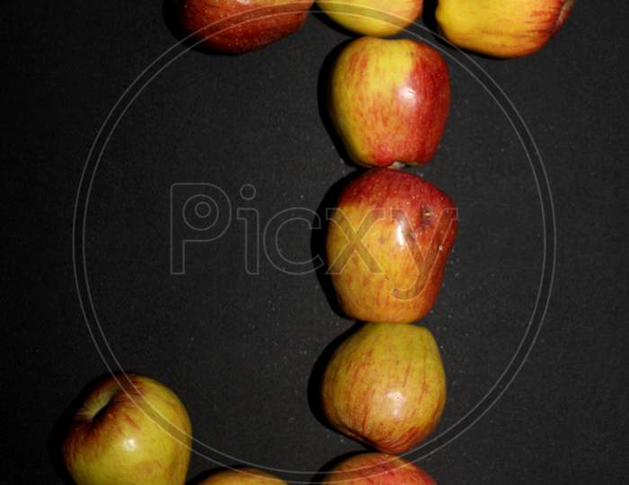 Alphabetical Letter J  With Apples Over An isolated Black Background