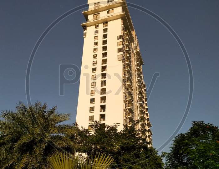 A View Of High Rise Apartment Building Over Sky in Background