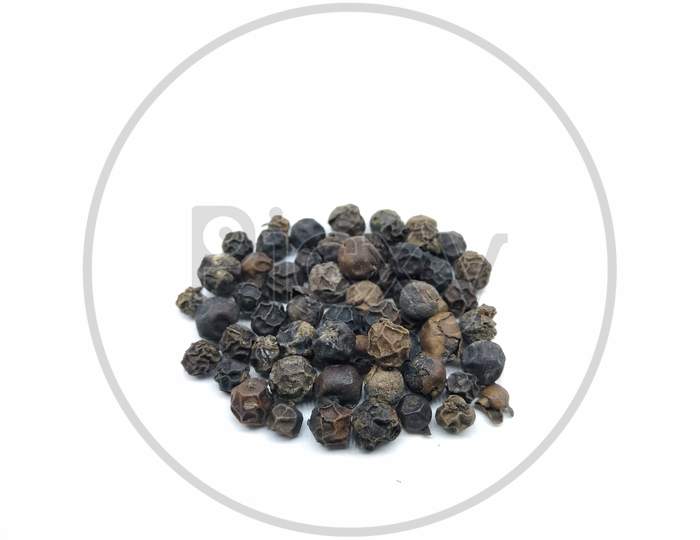 Black Pepper Corns Or Pepper Seeds Over an Isolated White Background