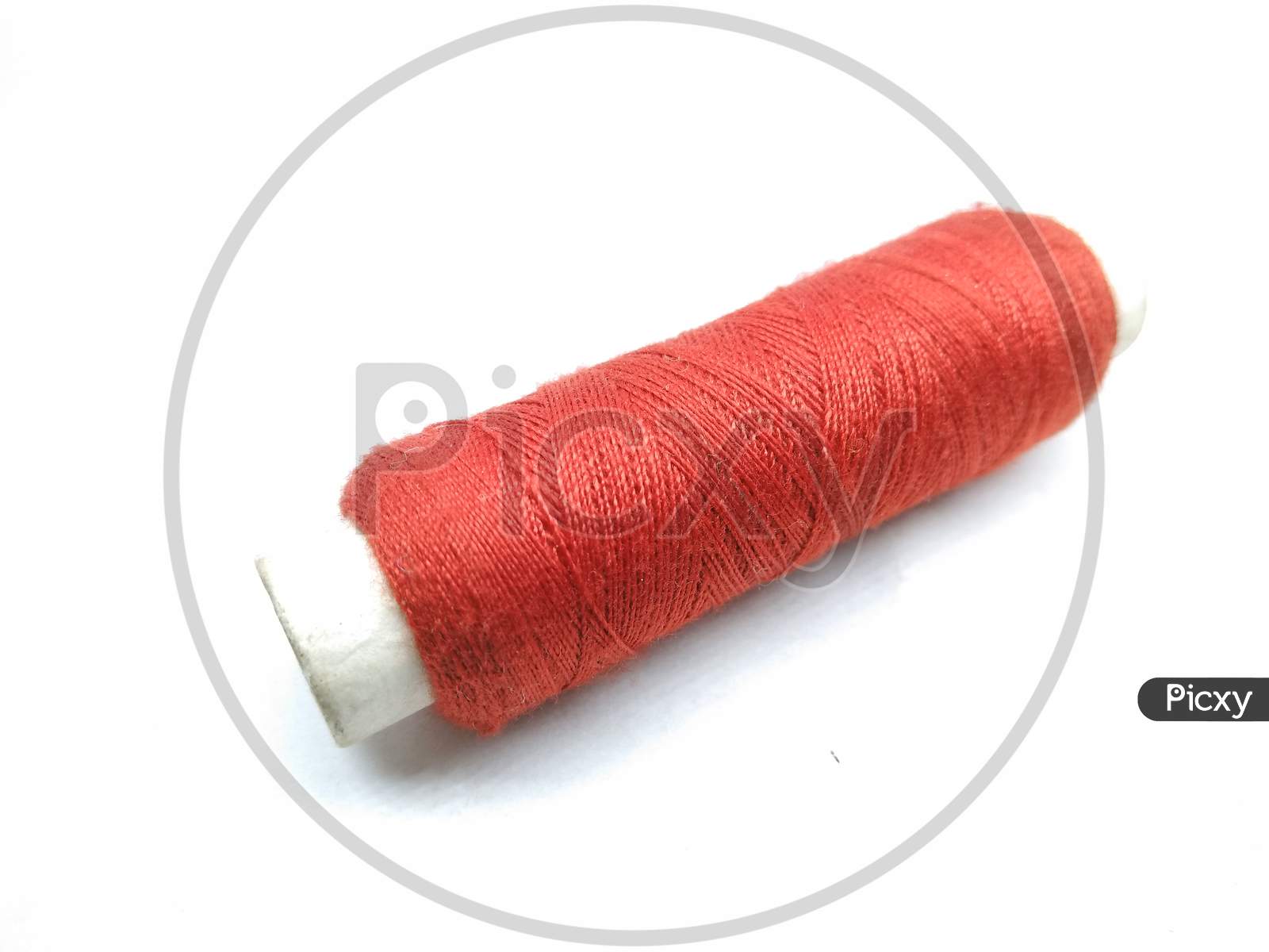 Red Thread Roll On White Background