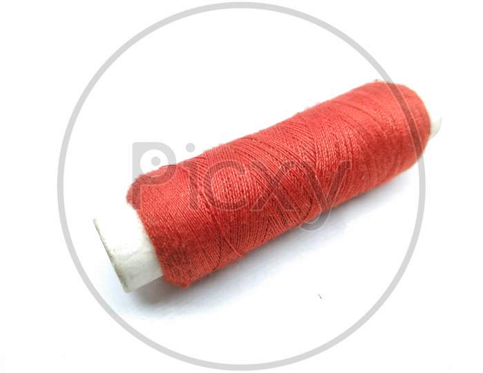 Red Thread Roll On White Background