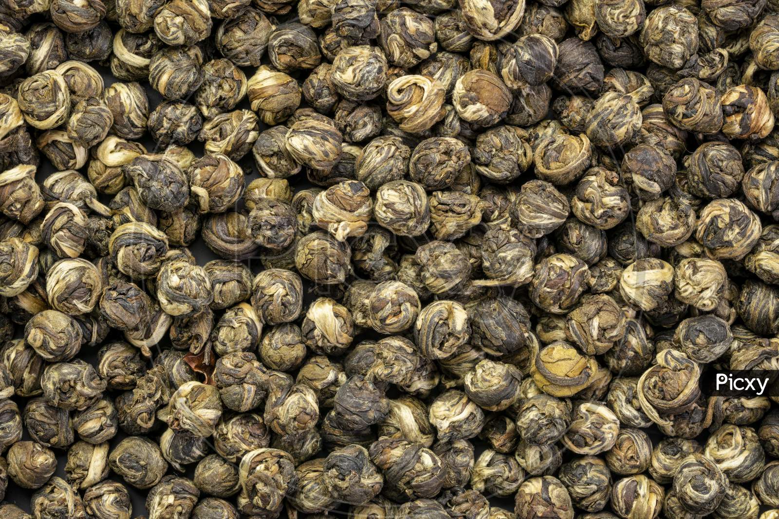 Closeup Background Of Hand-Rolled Jasmine Dragon Pearl Green Tea