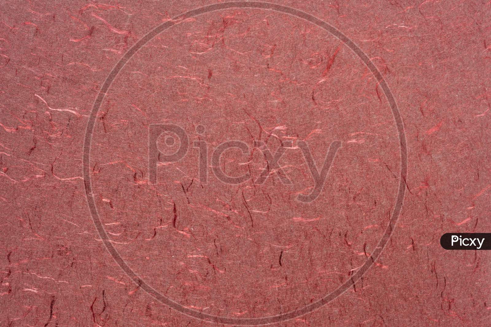 Background And Texture Of Red Handmade Indian Paper Created From Recycled Cotton Fabric With Silk Fibers