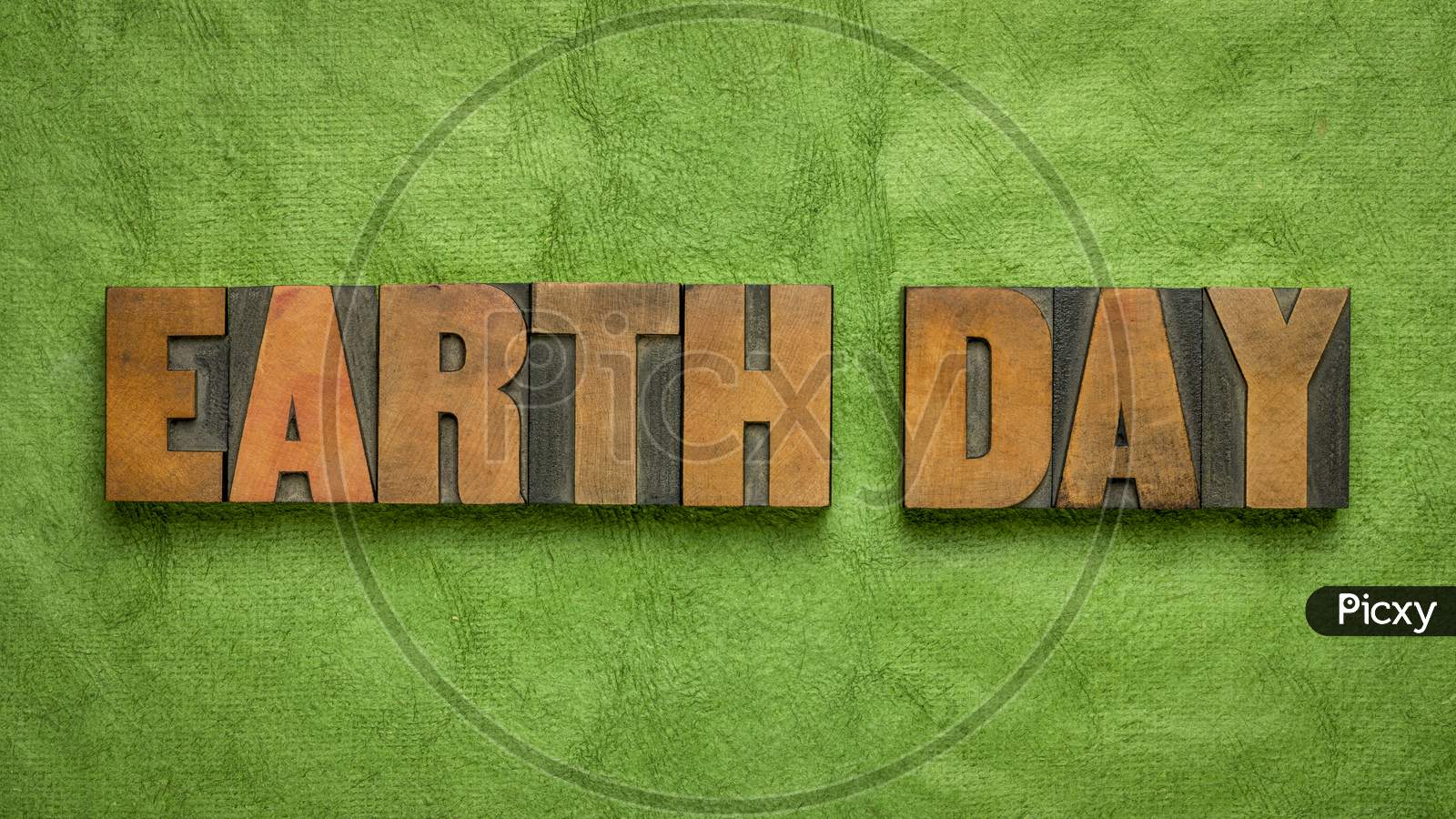 Earth Day - Annual Event Celebrated On April 22 To Demonstrate Support For Environmental Protection, Word Abstract In Letterpress Wood Type Against Green Handmade Paper