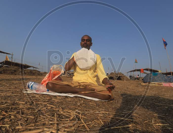 A Devotee Offering Prayers At The Bank Of River ganga in  Prayagraj