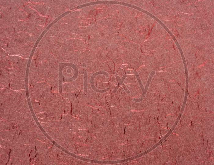 Background And Texture Of Red Handmade Indian Paper Created From Recycled Cotton Fabric With Silk Fibers