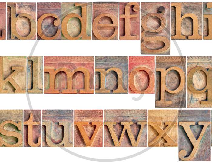 Complete English Lowercase Alphabet - A High Resolution Collage Of 26 Isolated Vintage Wood Letterpress Printing Blocks, Stained By Color Inks