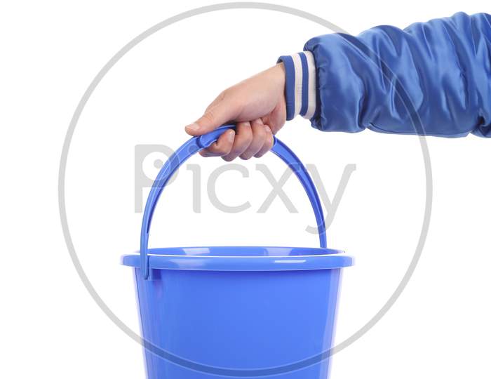Hand Holding Blue Bucket. Isolated On A White Background.